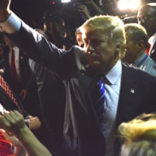 Donald Trump waves to supporters following a rally in Hampton, New Hampshire on Aug. 14, 2015.